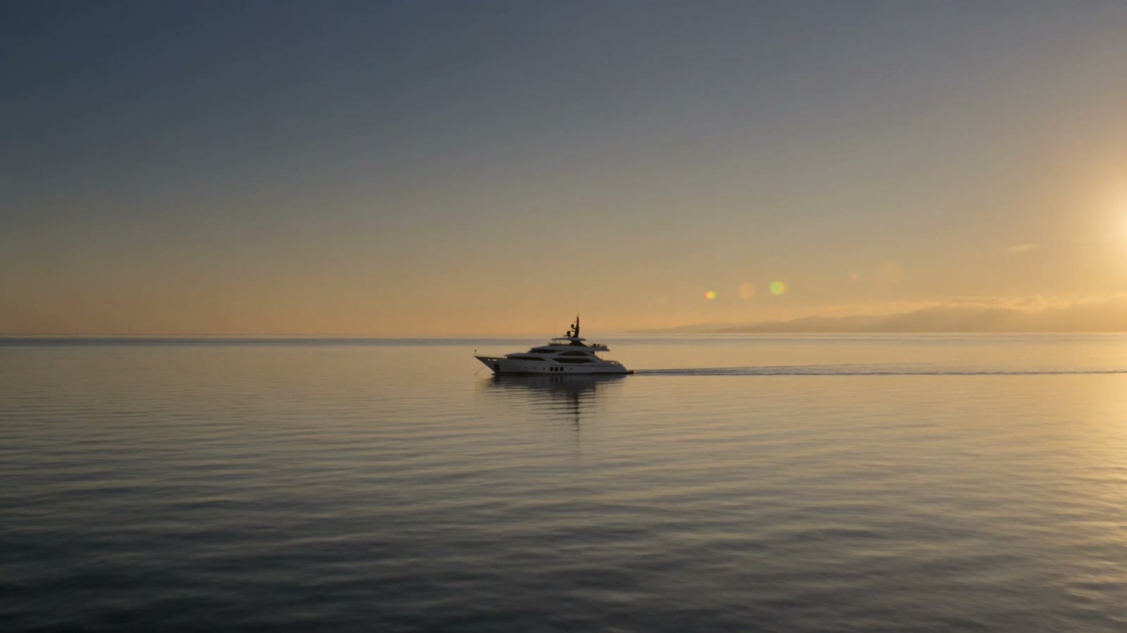 A luxury yacht on a calm golden sea at dusk